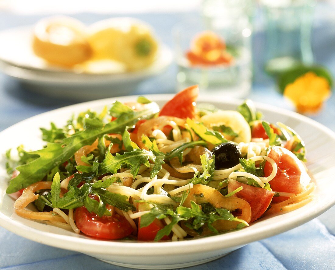 Spaghetti salad with vegetables and rocket