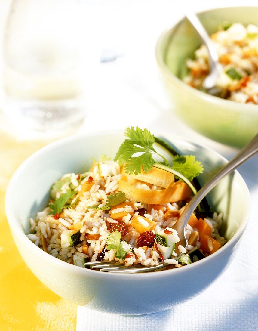 Rice salad with vegetables, chili and raisins