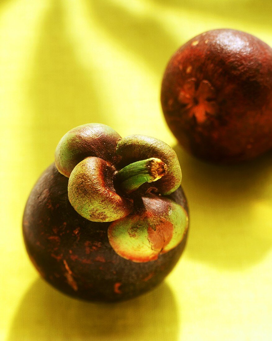 Mangosteens, yellow background