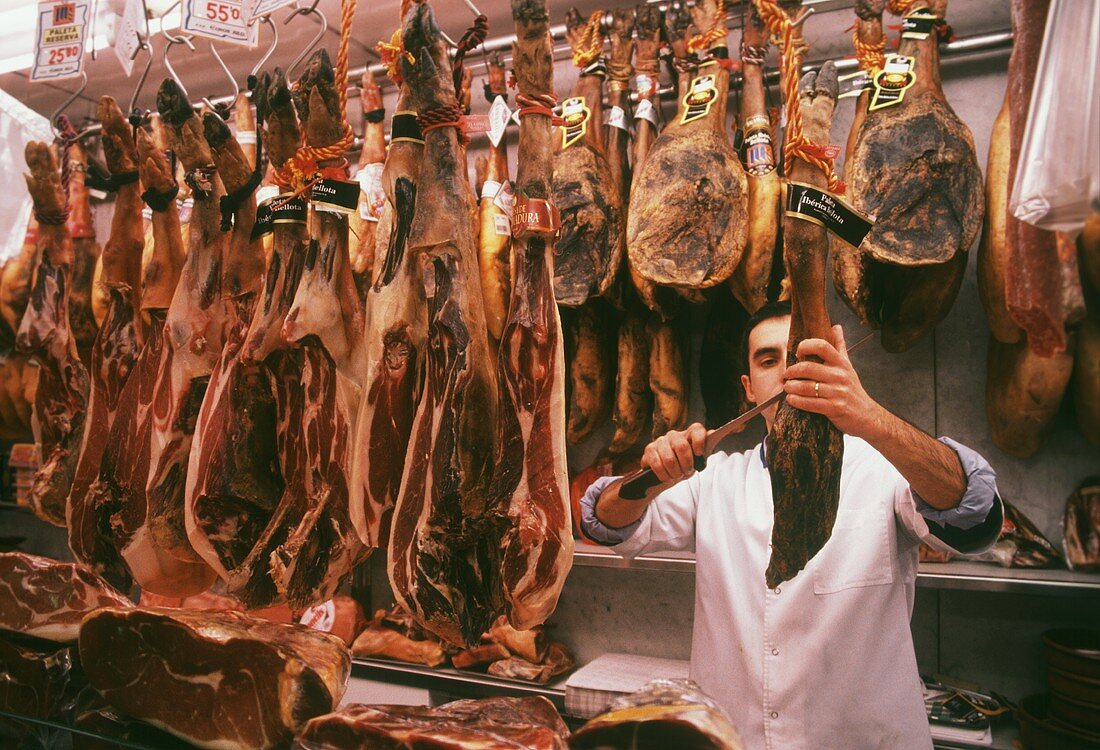 Butcher cutting ham (Paleta Iberica Bellota)