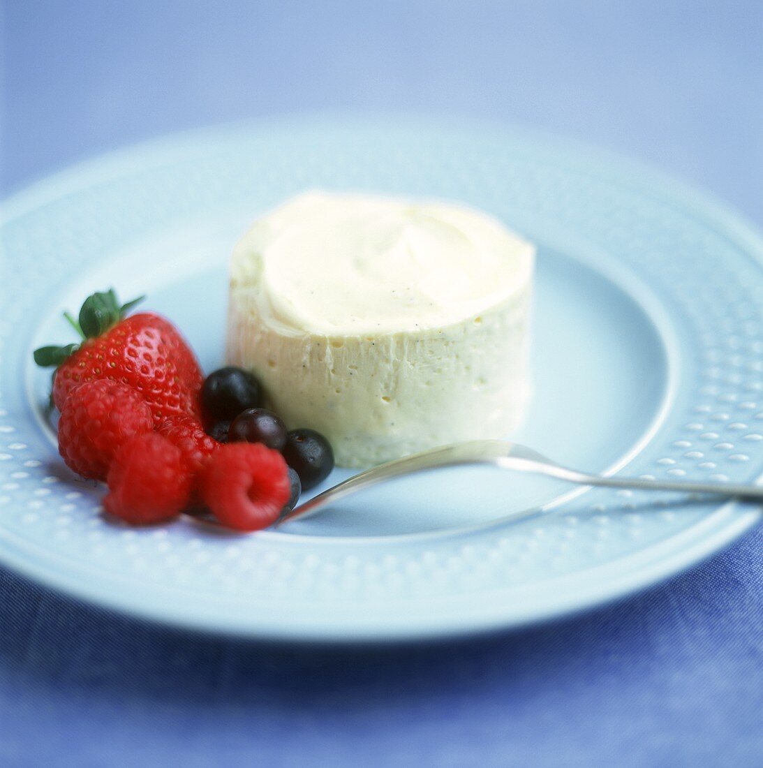 Vanilla ice cream on plate with fresh berries