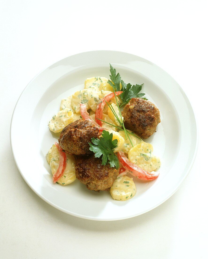 Potato salad with herbs, with meatballs