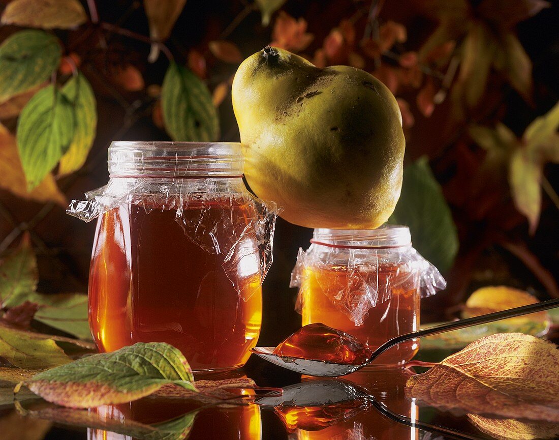 Two jars of quince jelly and one quince