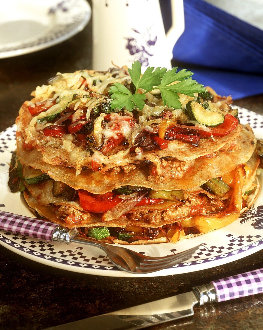 Baked pancake tower with vegetables and mince