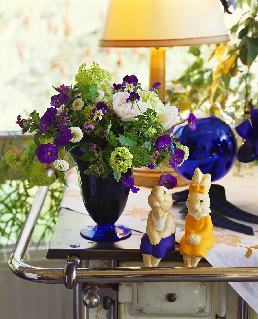 Two Easter Bunnies and bunch of flowers on cooker