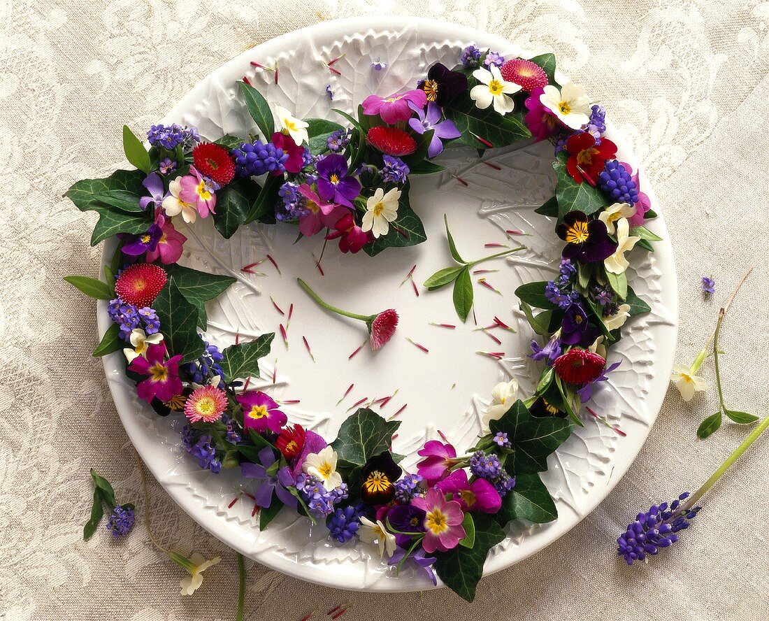 Heart-shaped flower wreath on white plate
