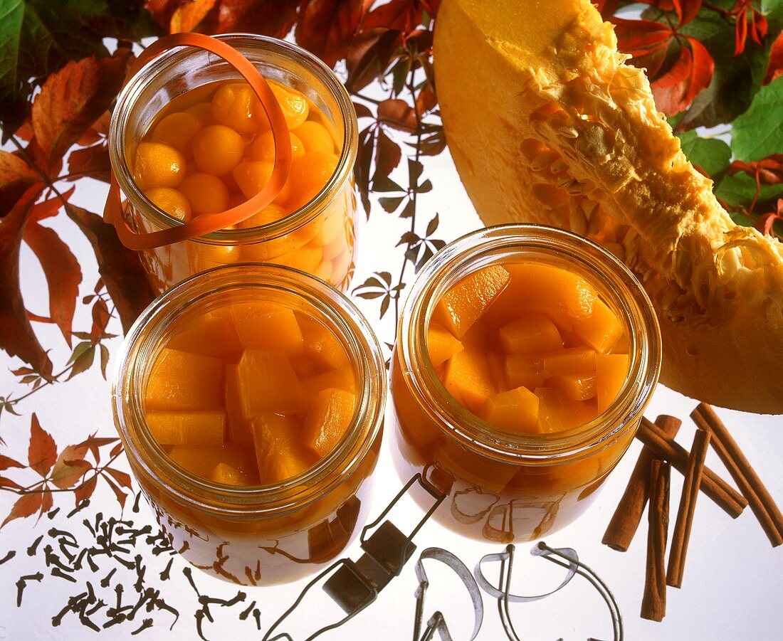 Bottled pumpkin in jars and a slice of pumpkin