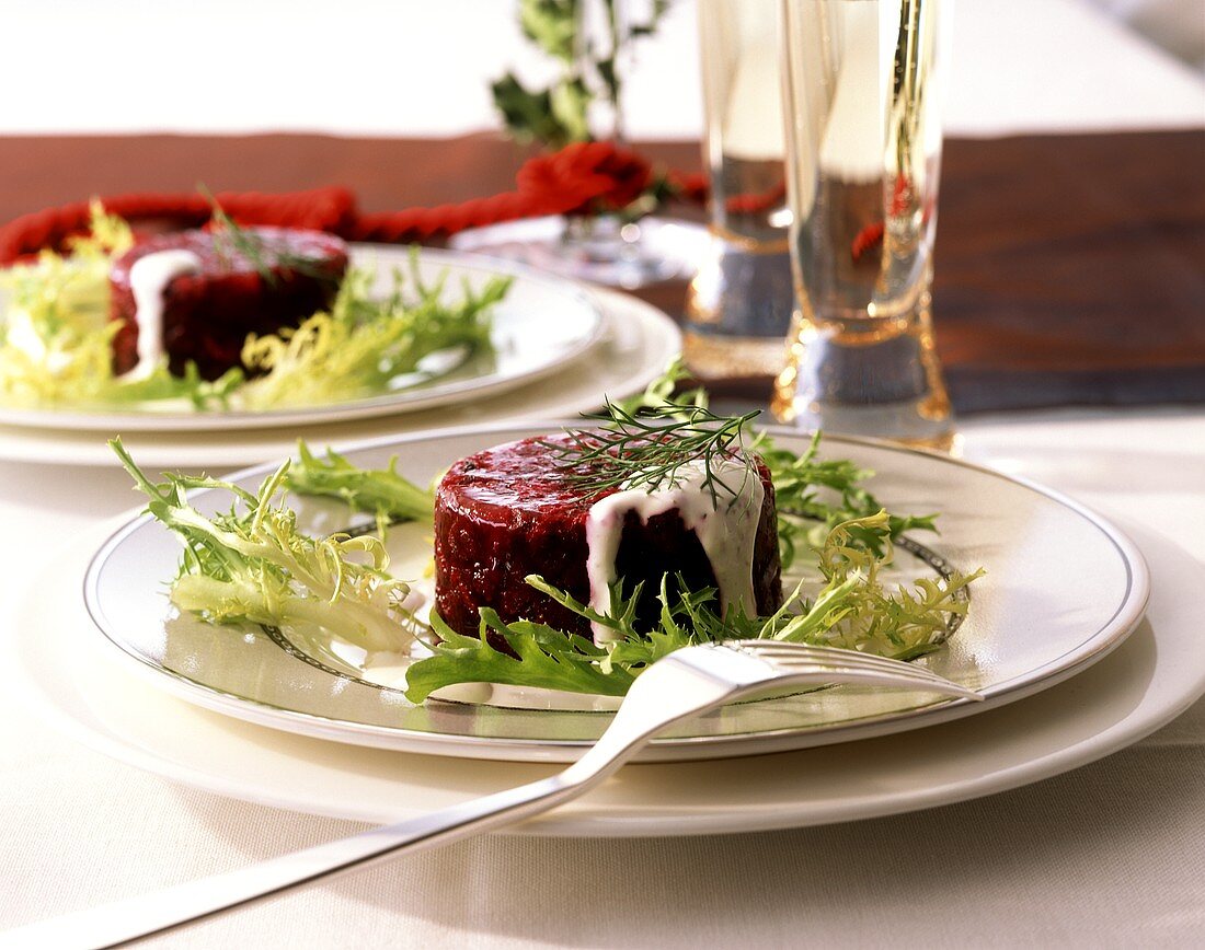 Beetroot in aspic with sour cream sauce and curly endive