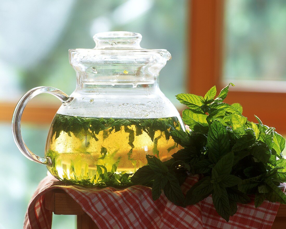 Peppermint tea and fresh mint leaves