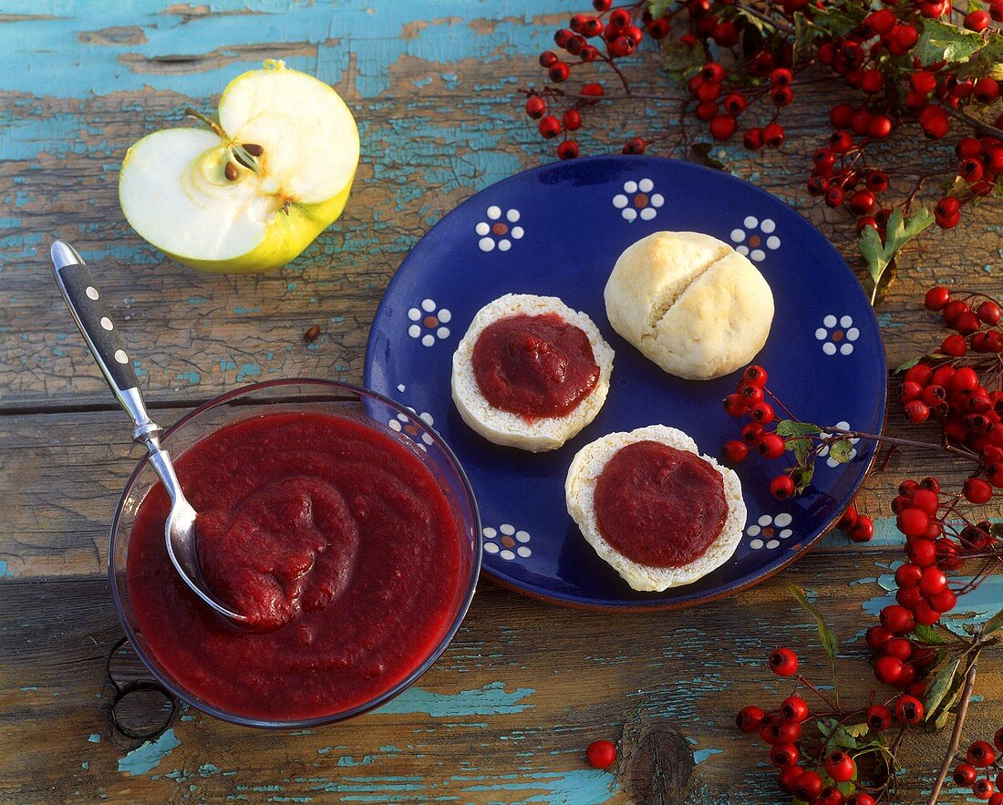 Haw puree with apples in bowl and on bread roll