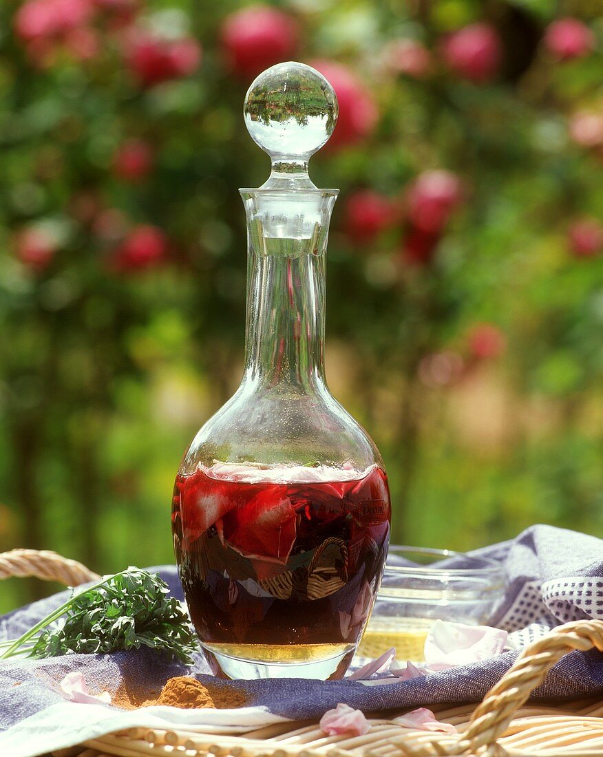 Liqueur with fresh rose petals in a carafe