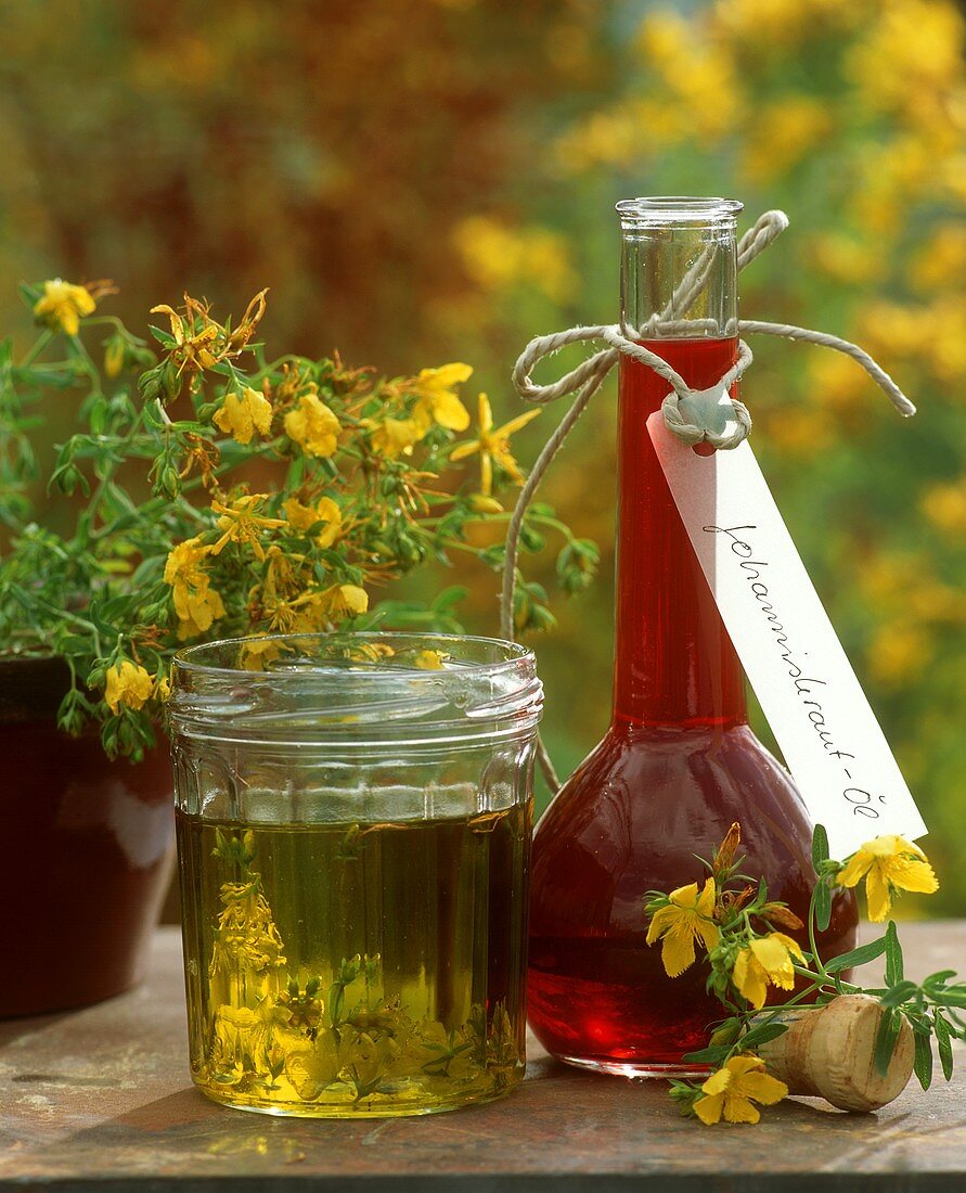 Bottle and glass of St. John's wort oil (medicinal oil)