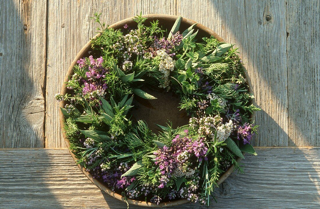 Herb wreath in a wooden bowl