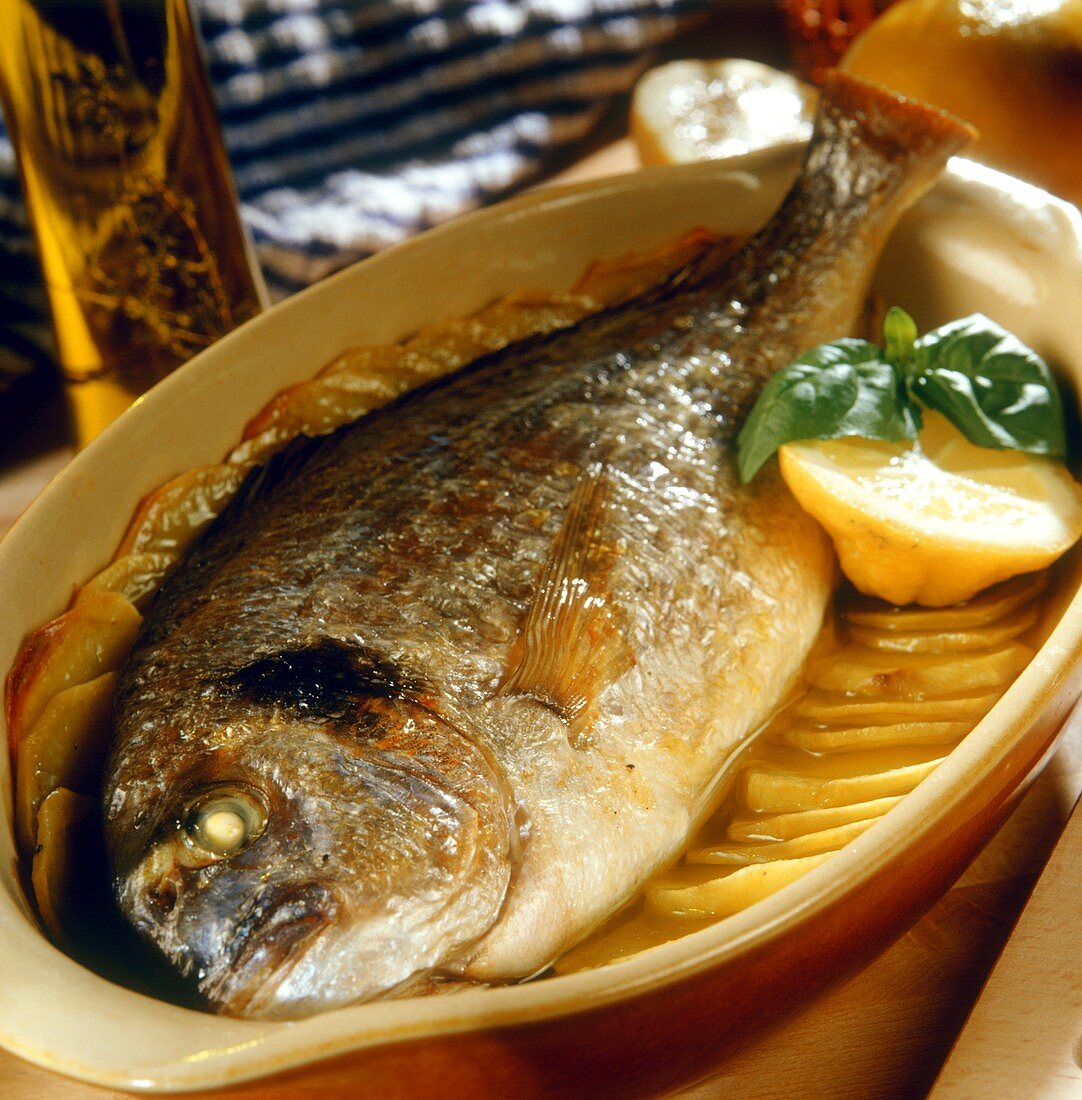 Baked sea bream with sliced potato