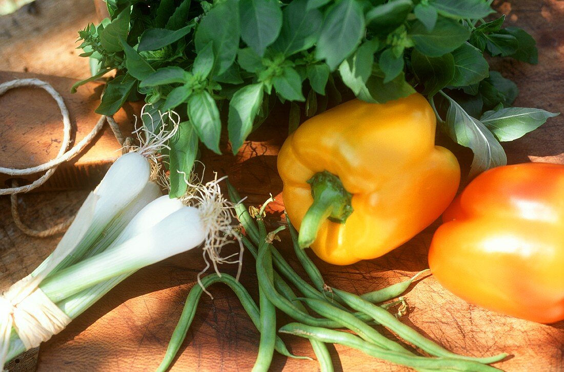 Vegetable still life with peppers, green beans & spring onions