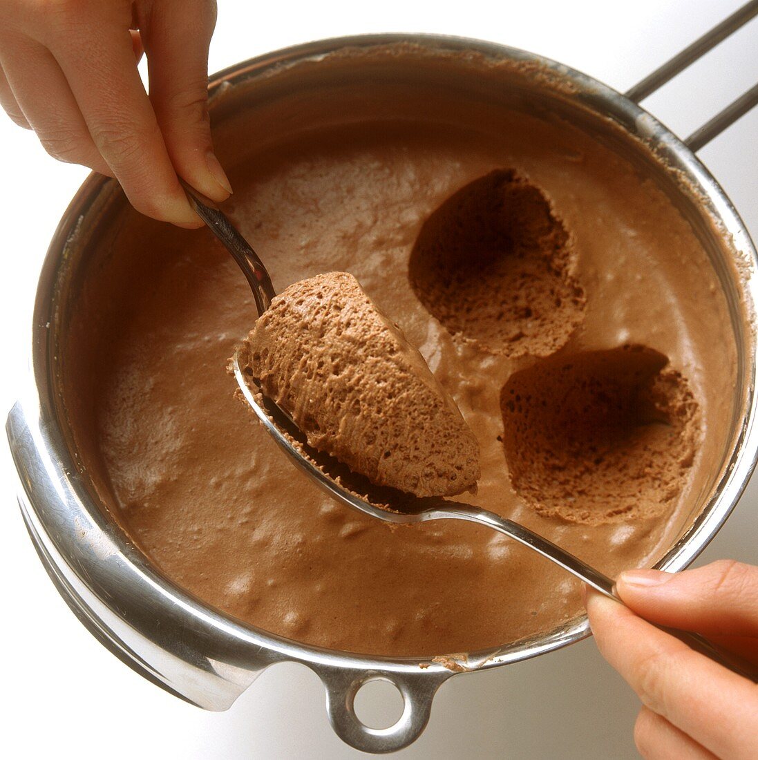 Spooning out spoonfuls of mousse au chocolat