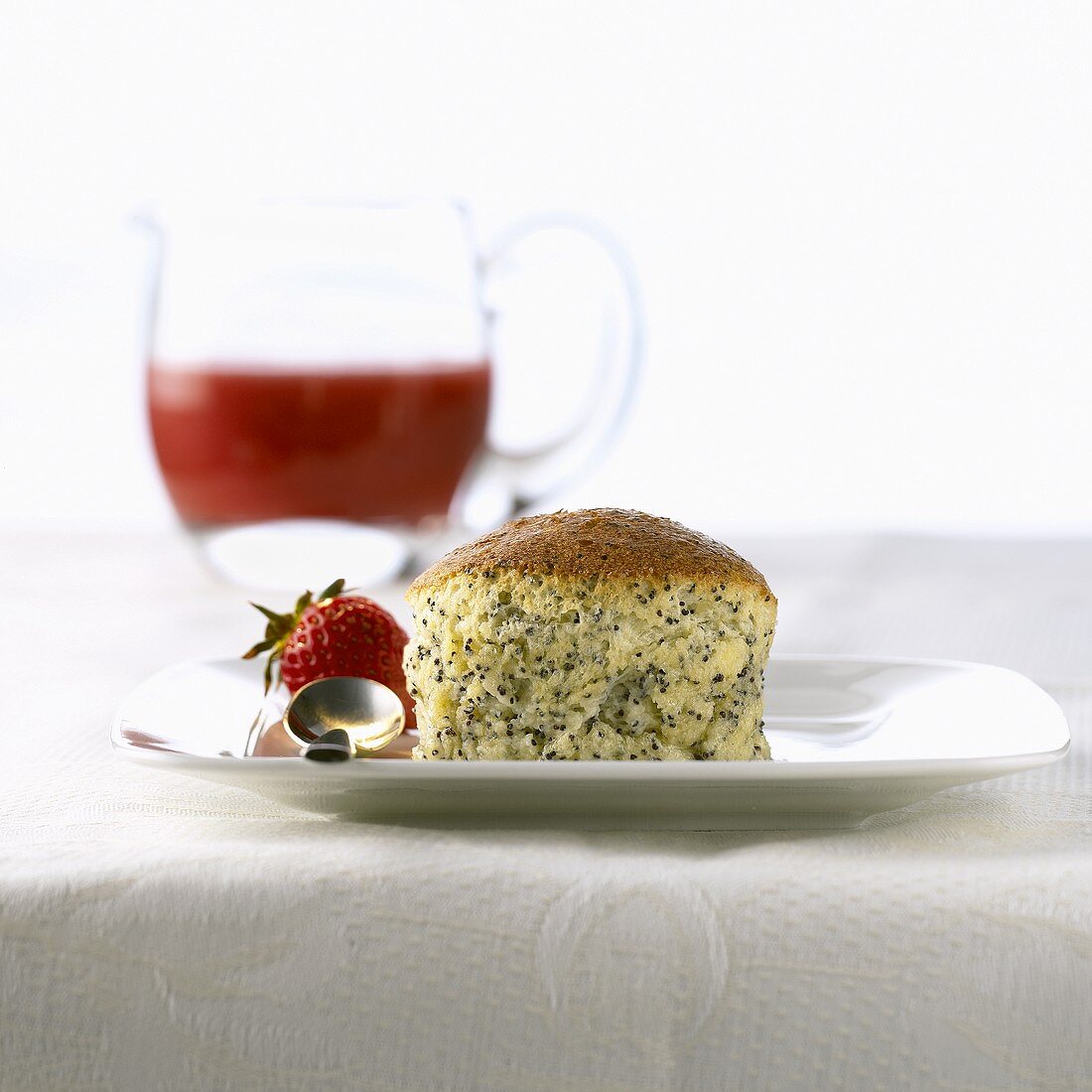 Poppy seed soufflé with strawberry sauce