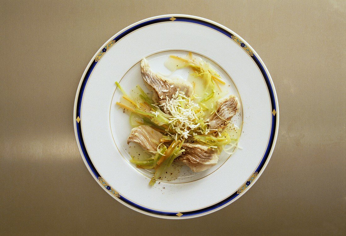 Poached catfish with strips of vegetables