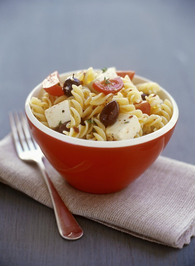 Pasta salad with sheep's cheese, olives and tomatoes