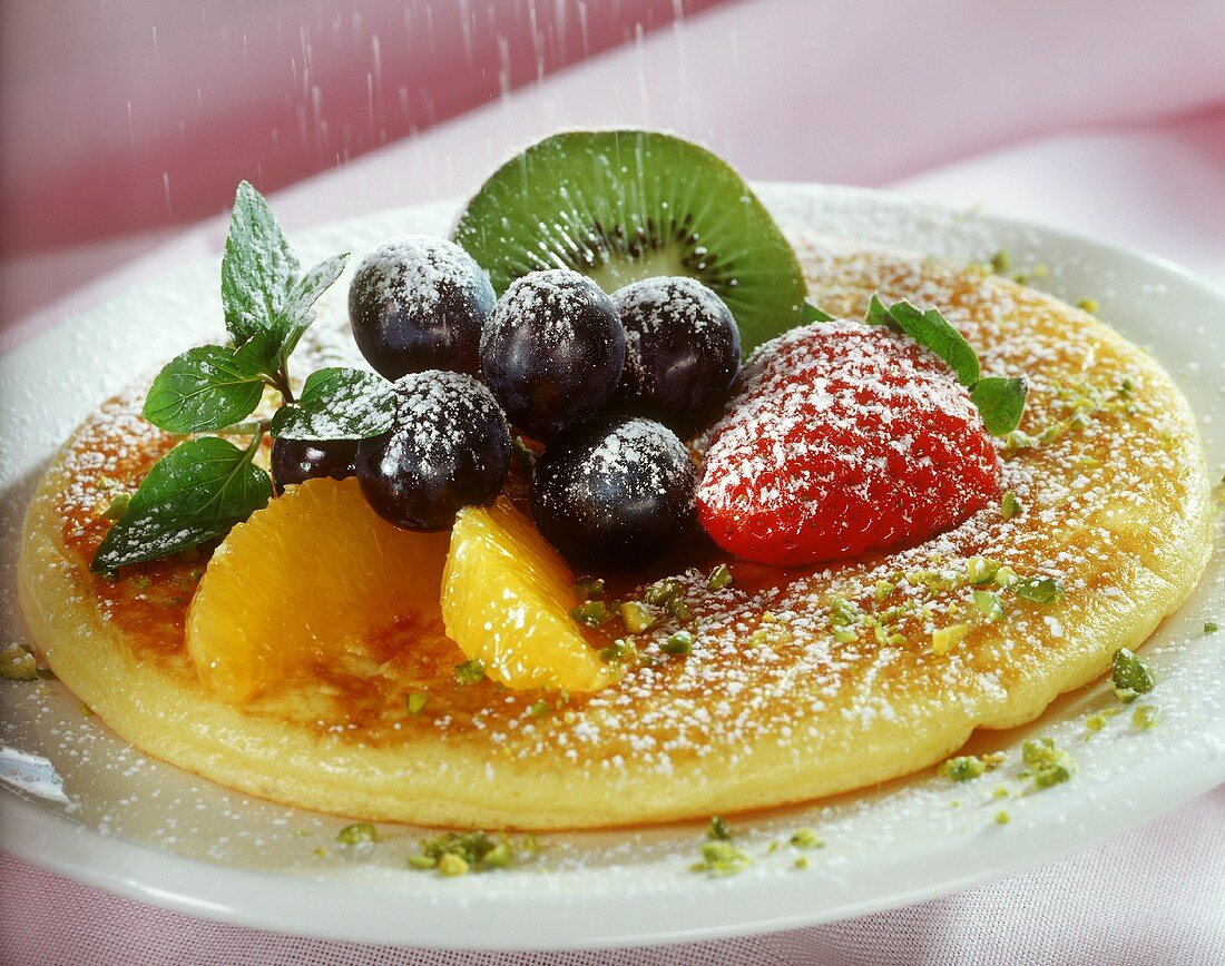 Pancakes with fresh fruit and icing sugar