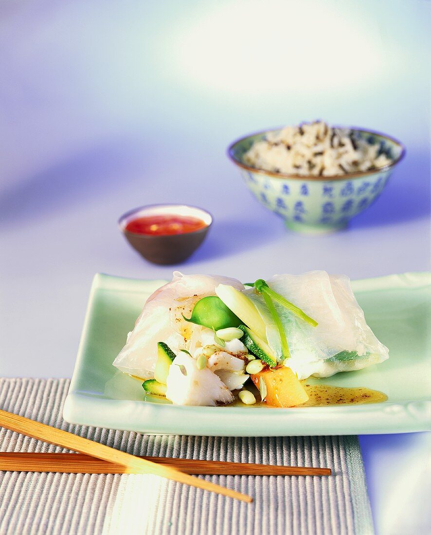 Cod fillet wrapped in rice paper with vegetables