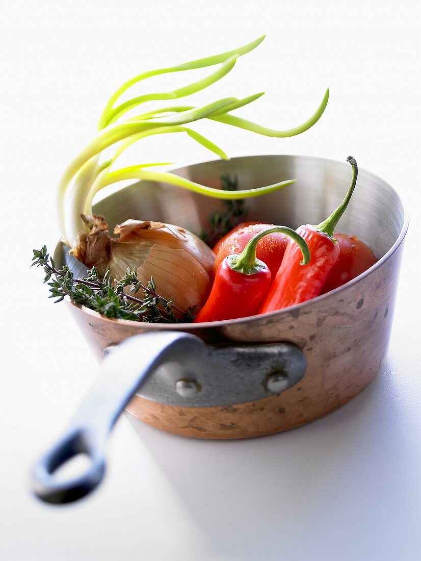 Chillies, tomatoes, onion and thyme in pan