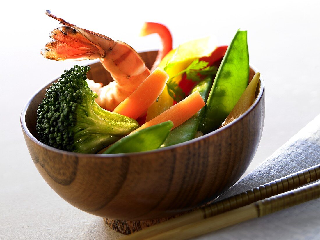 Bowl of vegetables and shrimps; chopsticks