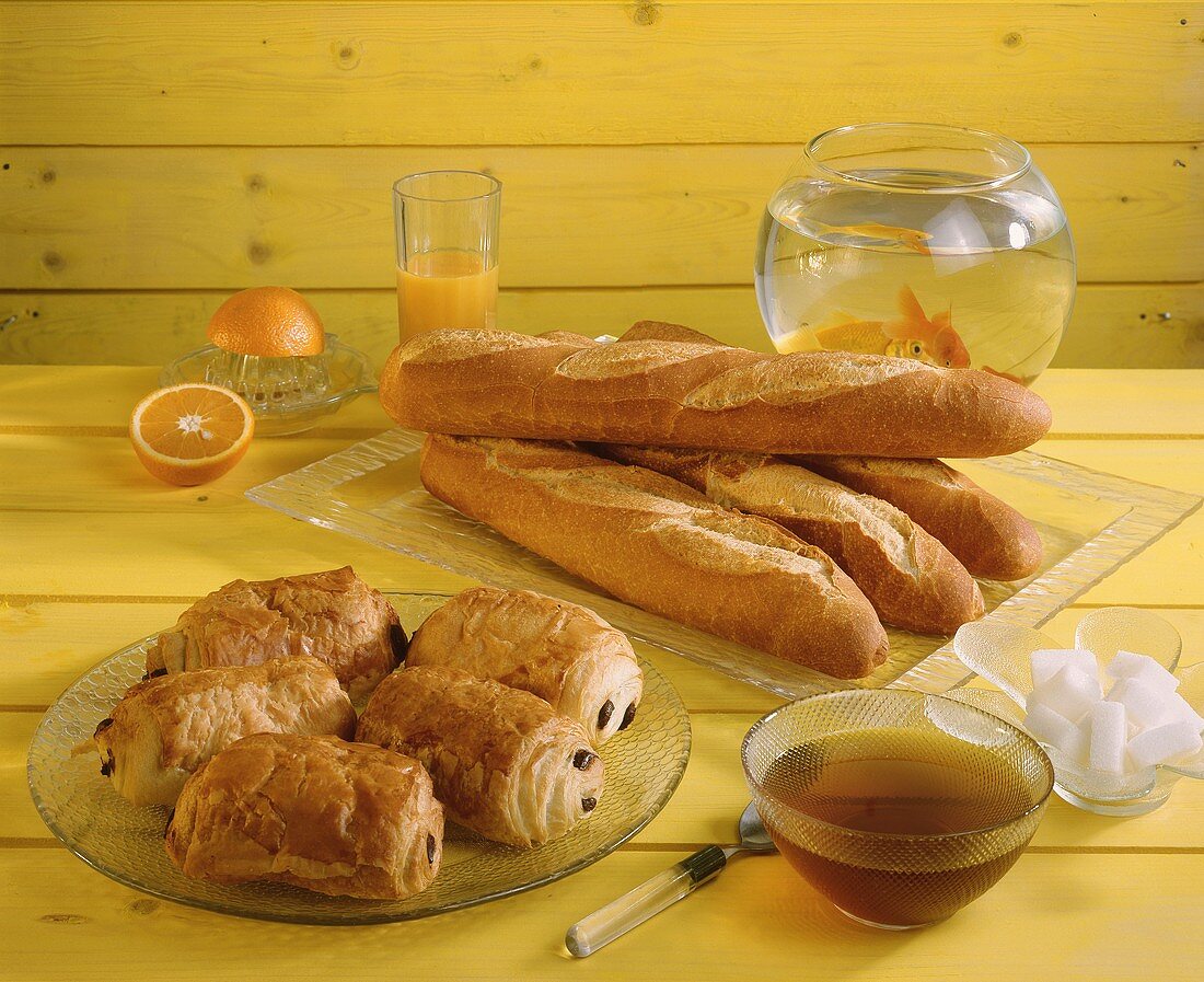 Baguettes, chocolate rolls, fresh orange juice and honey