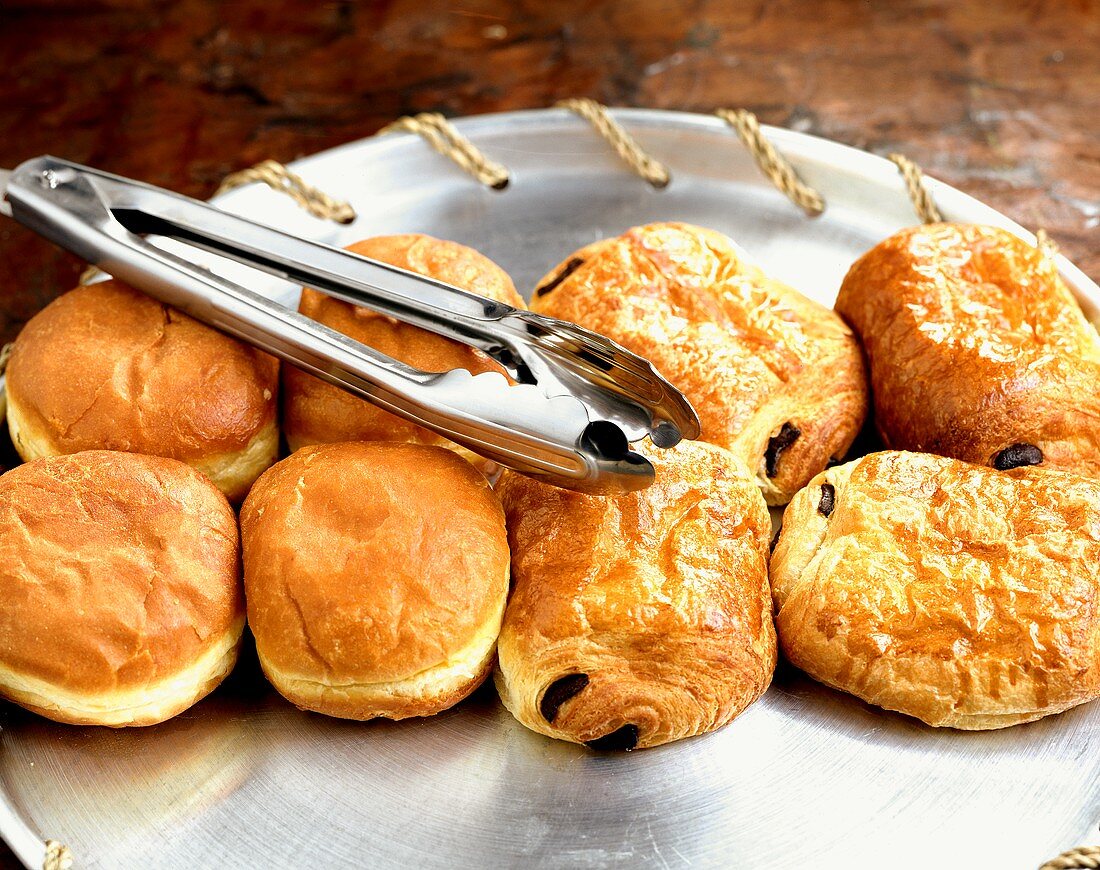 Chocolate croissants and doughnuts with cake tongues