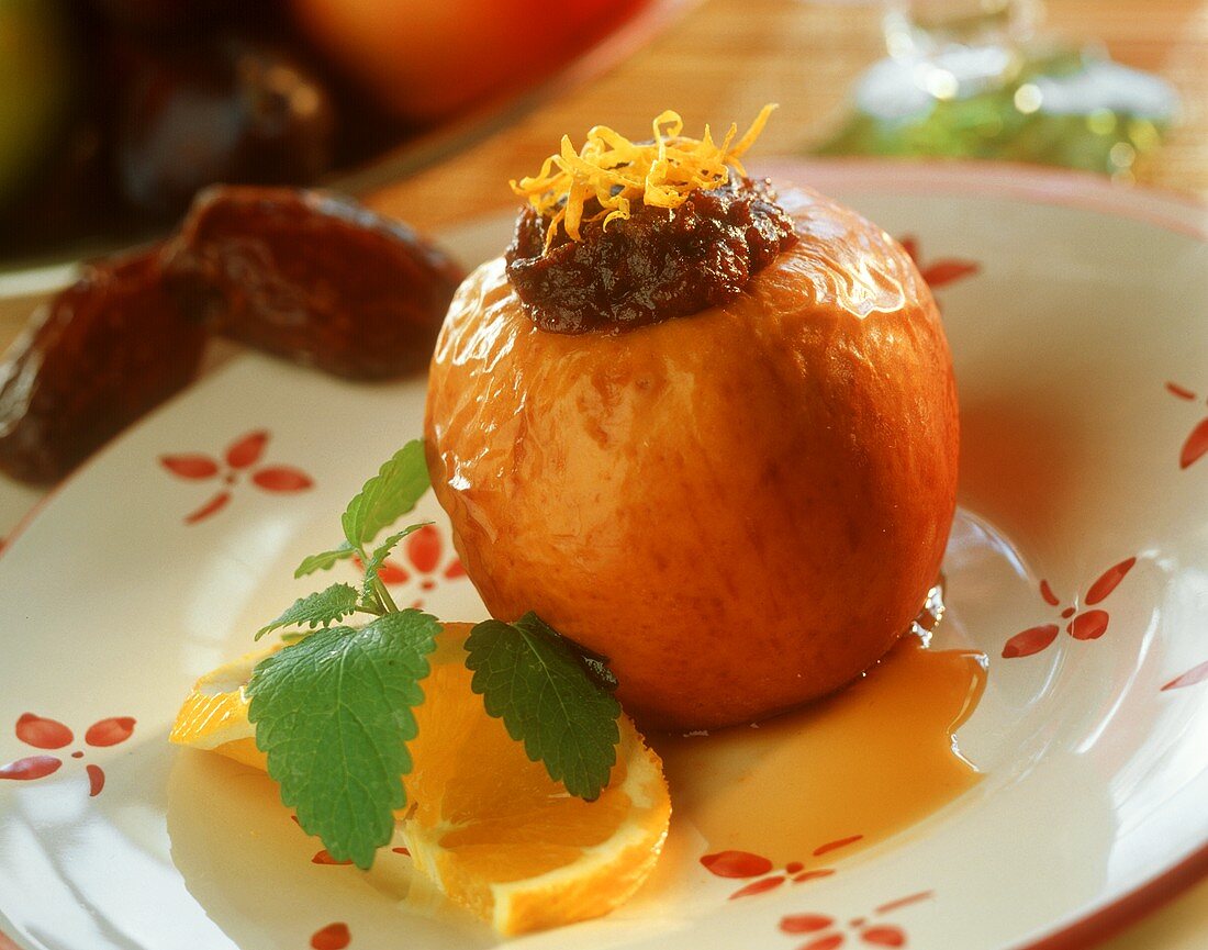 Baked apple with date filling and orange sauce
