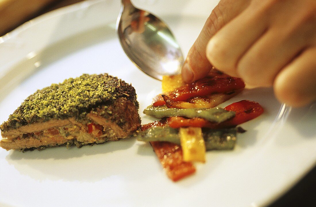 Stuffed lamb steak with herb crust and peppers