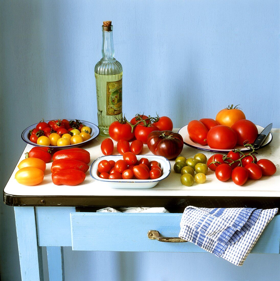 Various varieties of tomatoes on a kitchen table