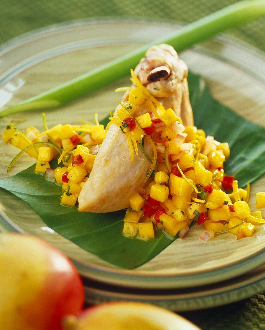 Chicken breast with mango chutney on banana leaf