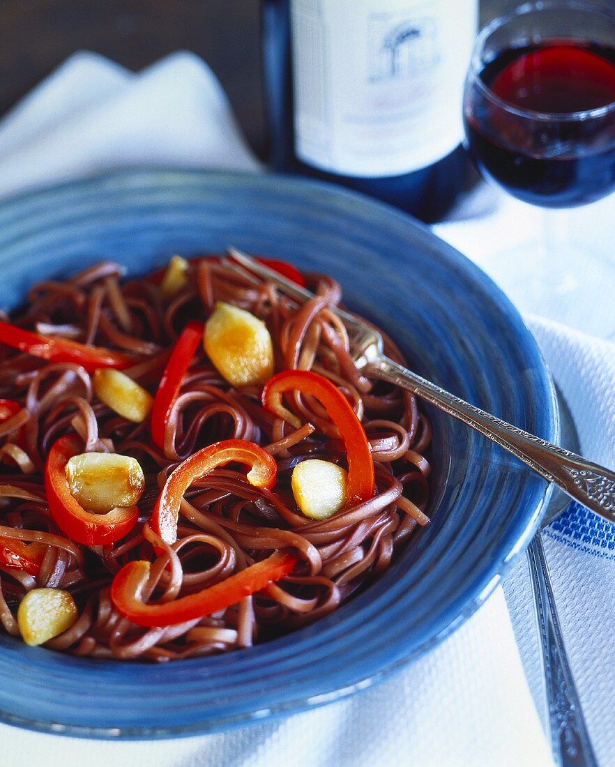 Fettuccini cooked in red wine with peppers and garlic