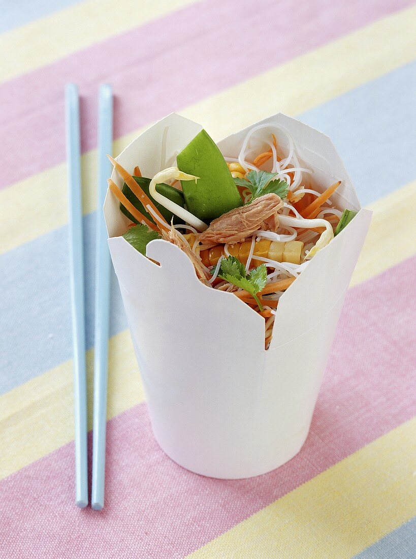 Rice noodles with tuna and vegetables in a take-away box