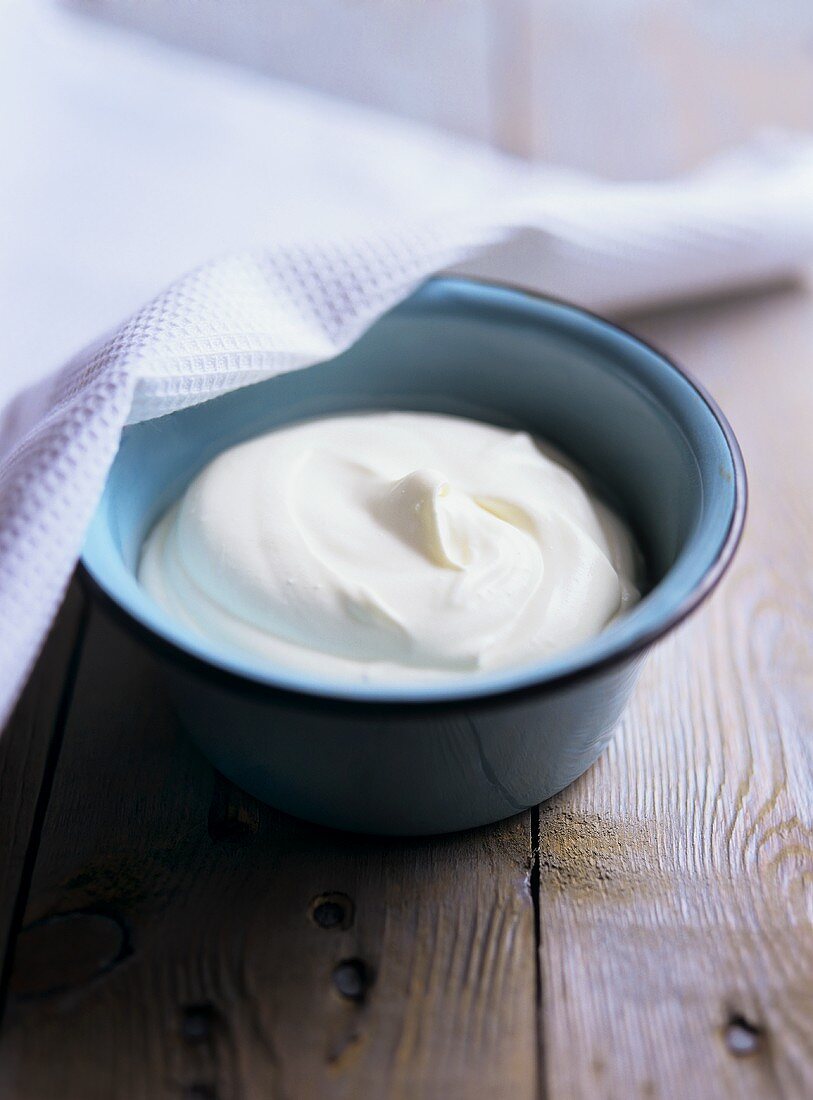 Fresh sour cream in a small bowl