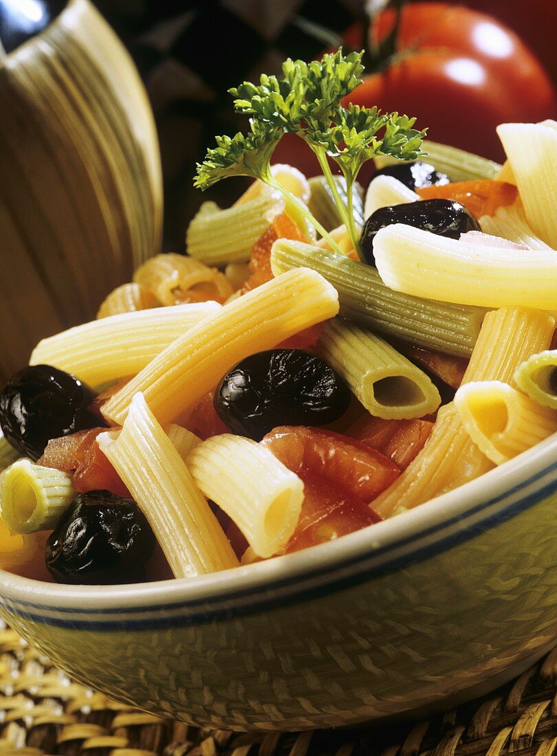 Penne tricolore with tomatoes and black olives