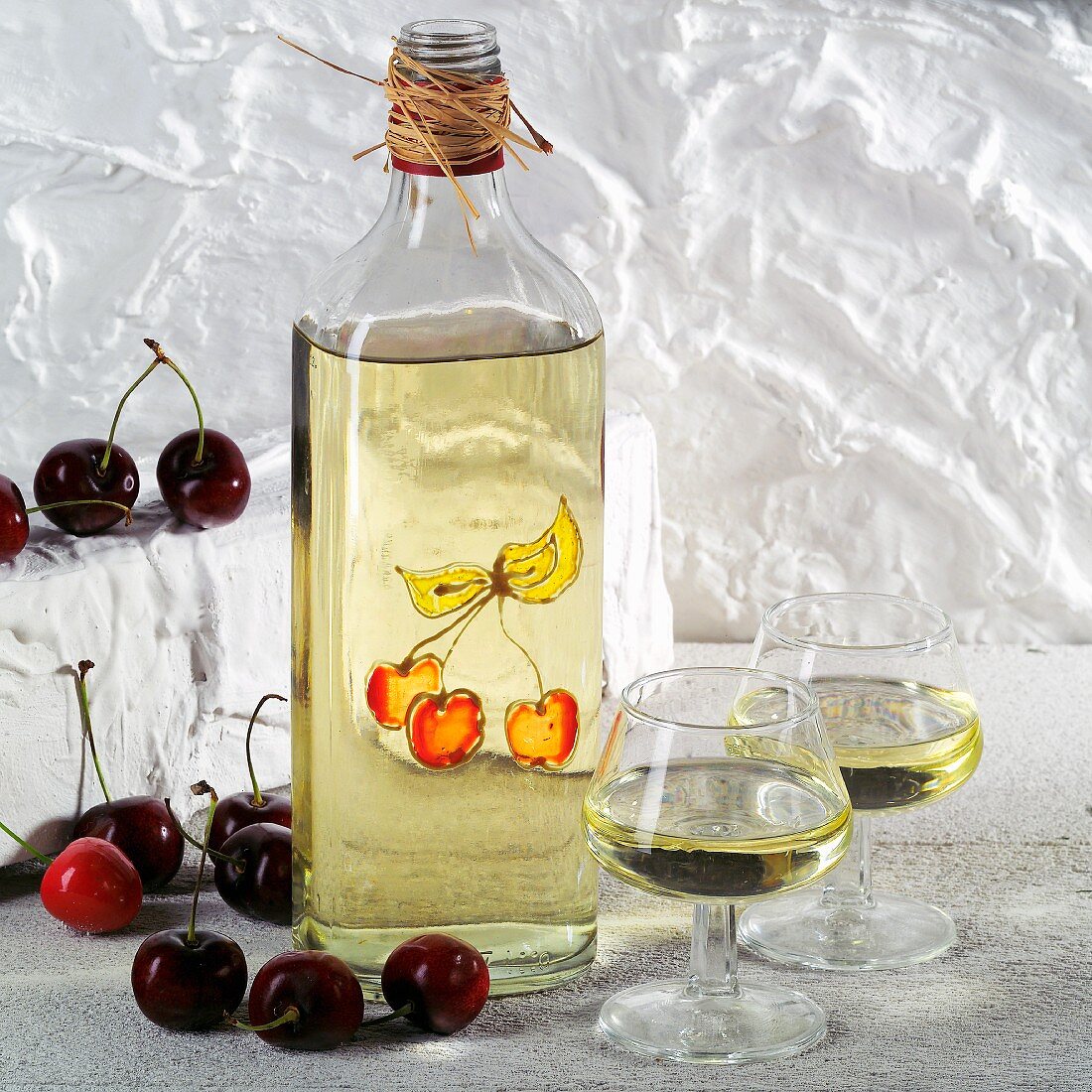 A bottle and two glasses of kirsch (cherry brandy)