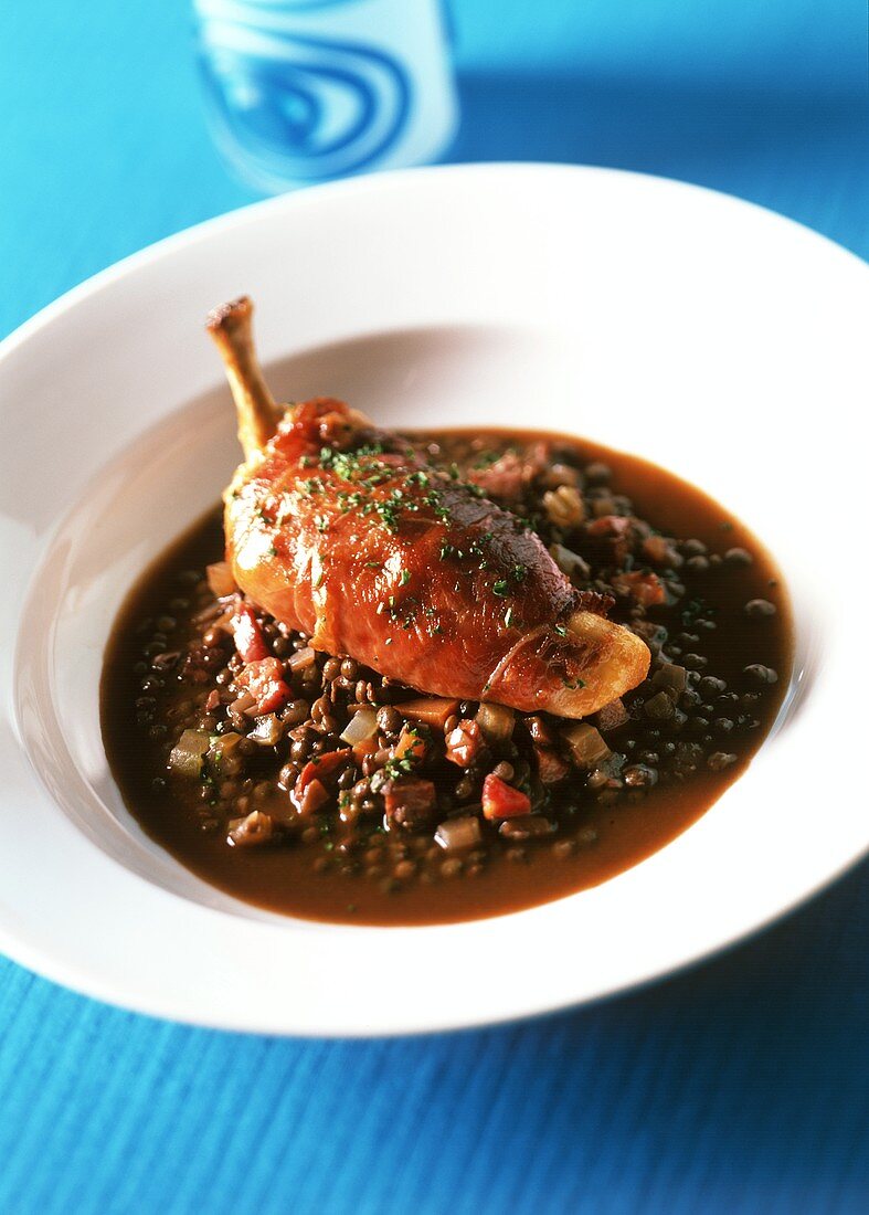 Chicken breast wrapped in ham on lentils