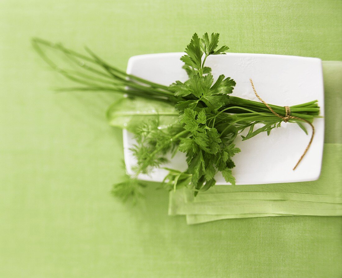 A bunch of herbs in a china bowl