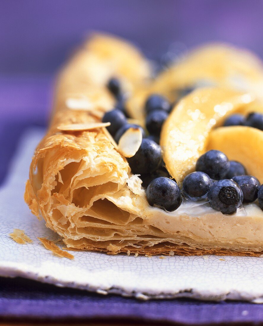 Puff pastry with blueberries, a piece cut