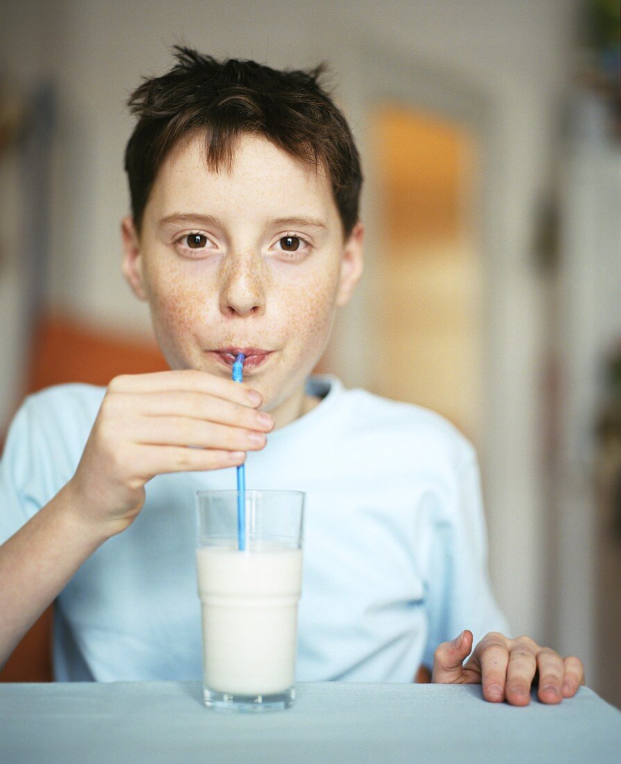 Boy drinking milk through straw