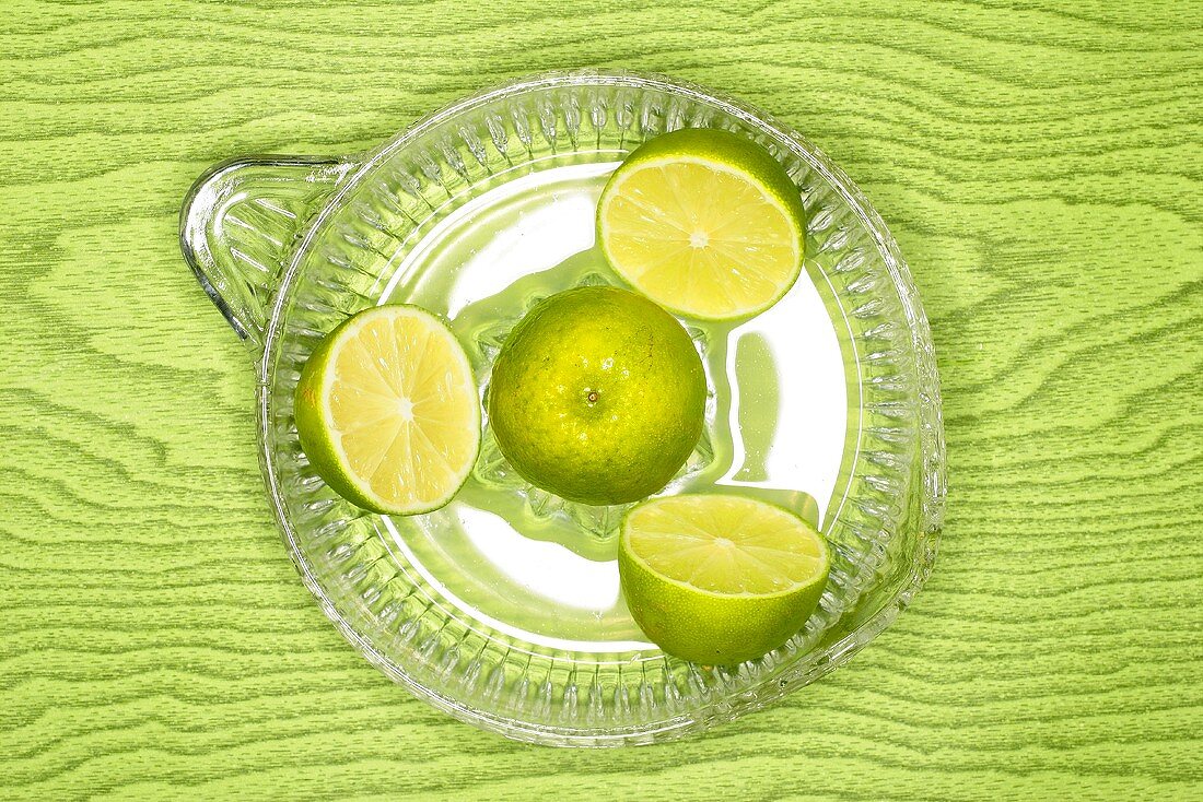 Limes in citrus squeezer