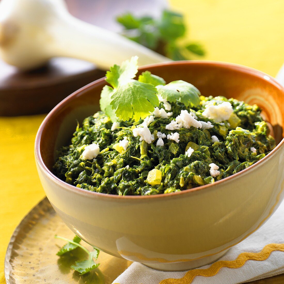 Spinach in a bowl, sprinkled with sheep's cheese (India)