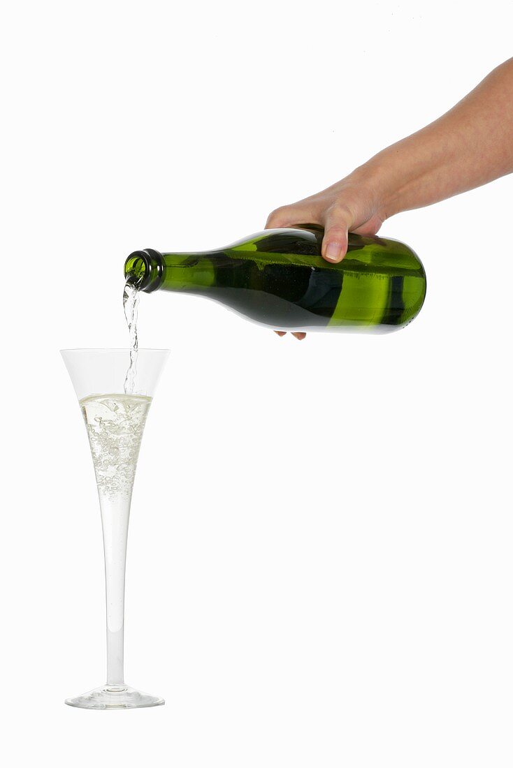 Woman's hand pouring champagne