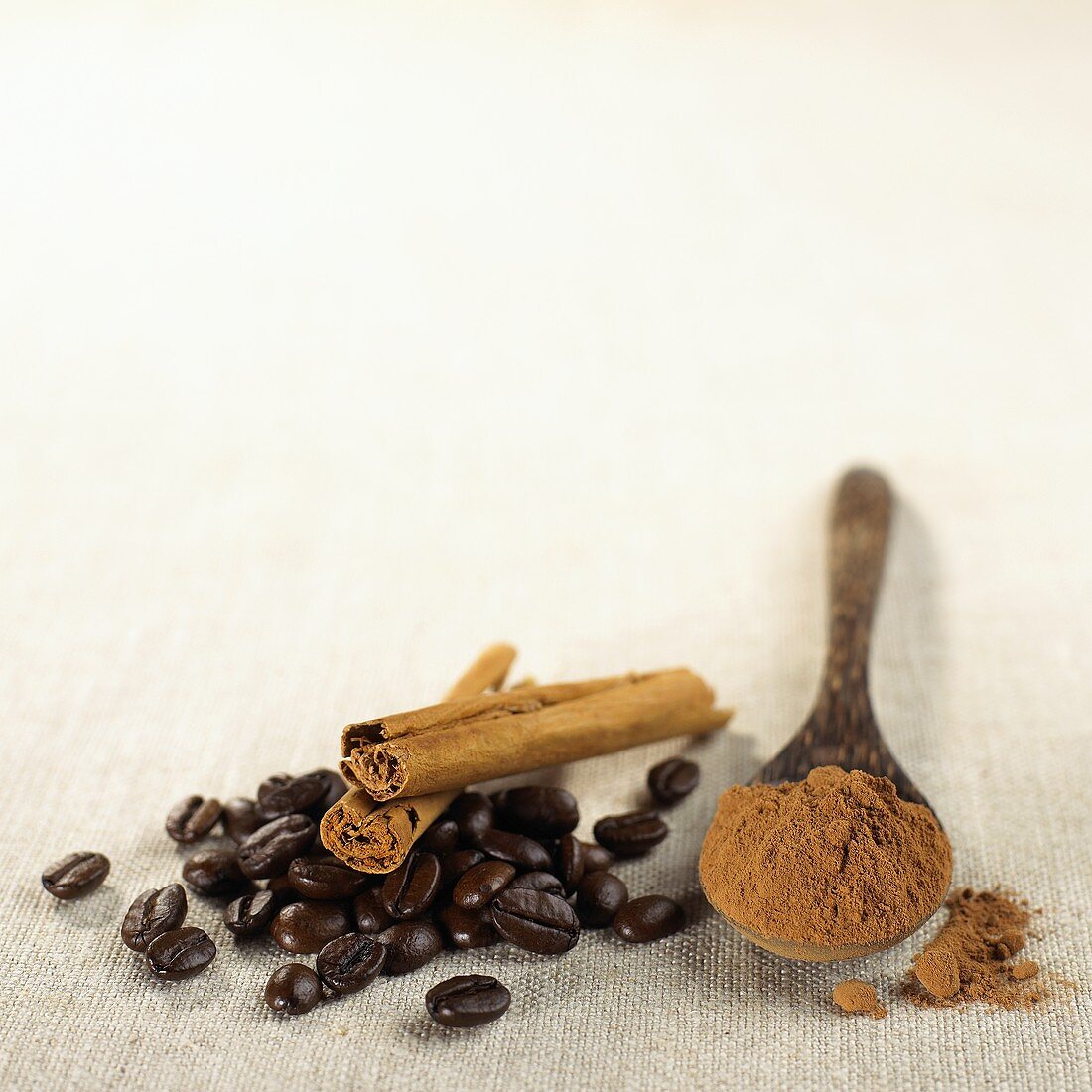 Coffee beans, cinnamon sticks and ground cinnamon
