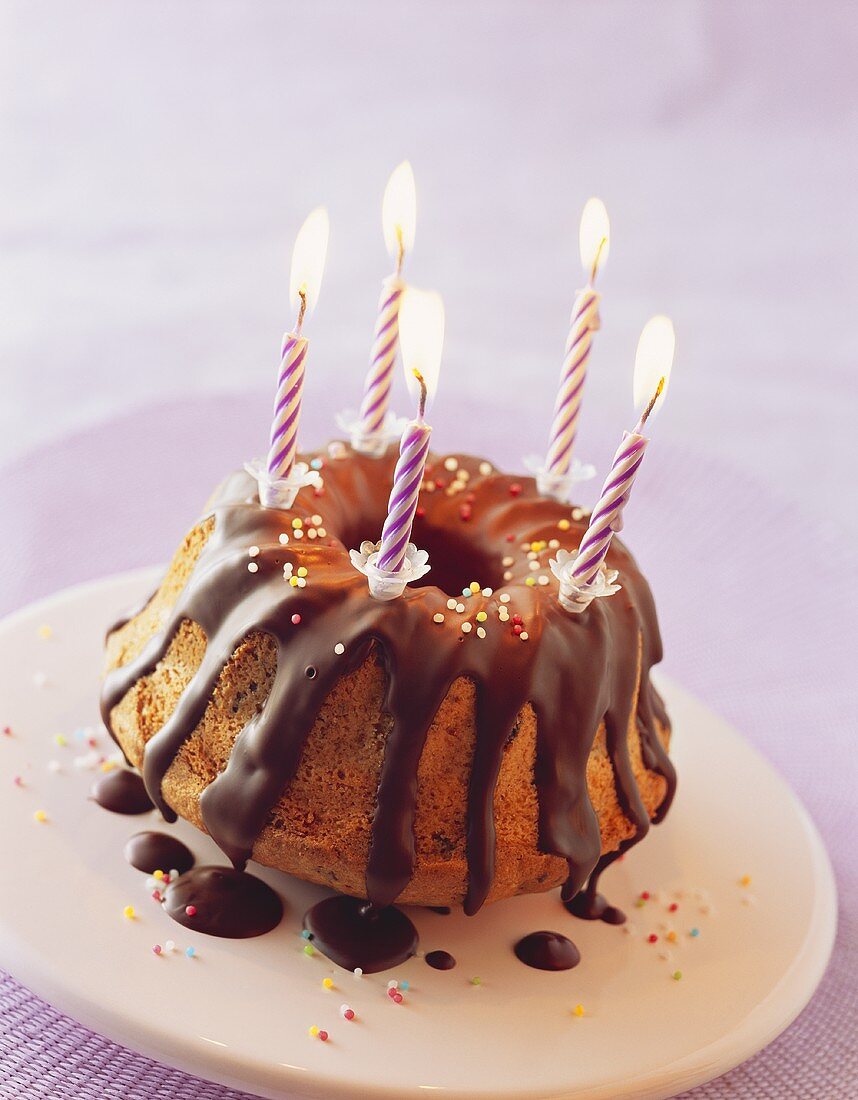 Gugelhupf with chocolate icing and candles