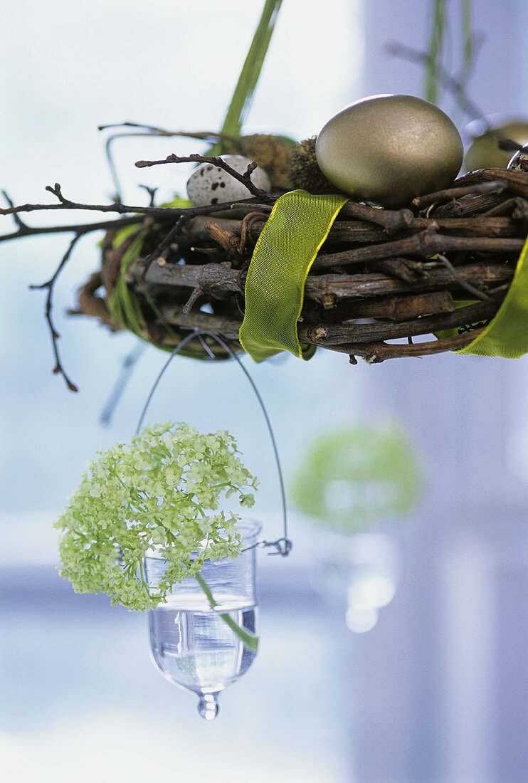 Willow wreath with hanging vase as Easter decoration