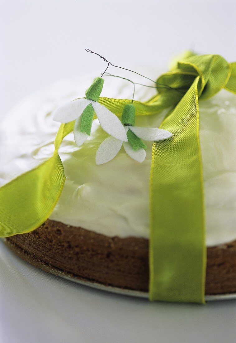 Chocolate cream cake with green bow