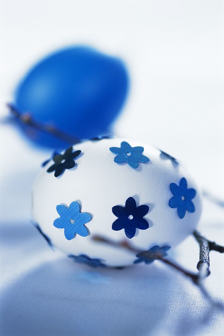 Two Easter eggs (decorated and painted in blue)